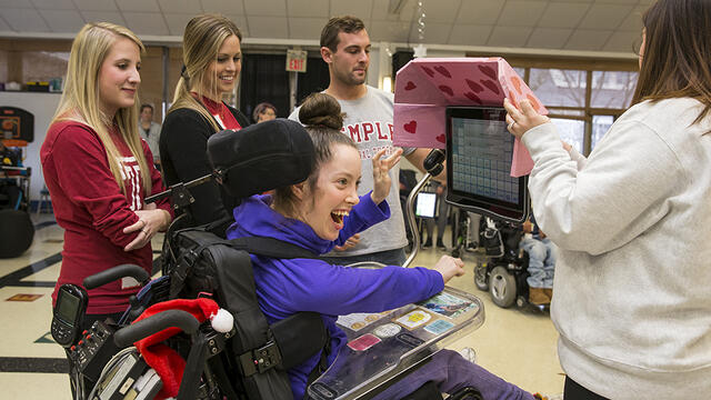Diana D Rich, a student, receiving a customized visor for her communication device.