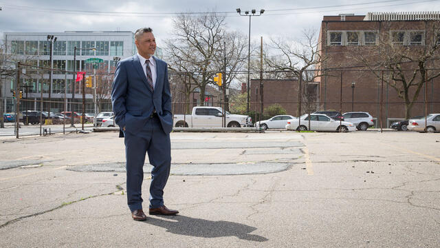 Gregory Anderson standing at the site of the proposed Alpha Center