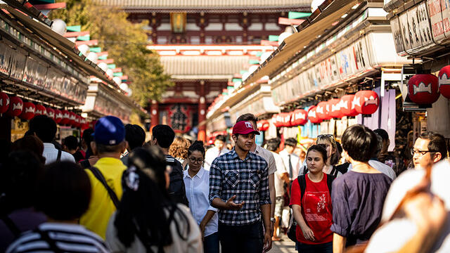 People walking down a street in Tokyo