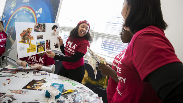 Image of women wearing cherry and white MLK Day shirts.