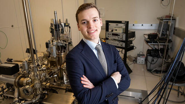 Marcus Forst, a senior physics major, stands in an applied physics lab