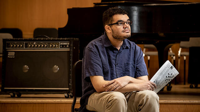 Ellis Hay holding his New York Times crossword puzzle