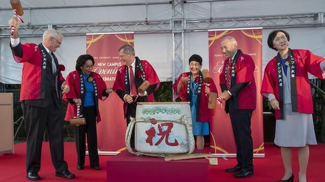 Temple University and Showa Women's University leadership break open a sake barrel to celebrate the official opening of TUJ's new campus.