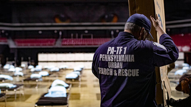 emergency worker setting up medical supplies at Liacouras Center