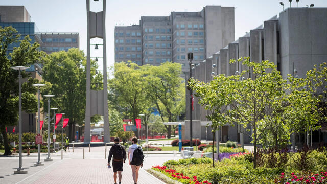 Students walk towards the Bell Tower on Main Campus.