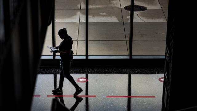 A person in silhouette walking through Morgan Hall.