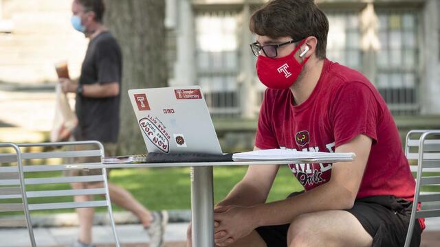 student with a lap top computer