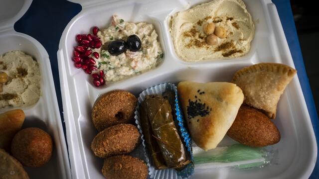 Image of Takeout containers of Syrian delicacies were distributed to guests of a virtual dinner.
