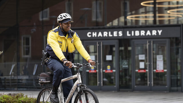 Officer Eliajah Lewis pictured on a bike outside Charles Library.