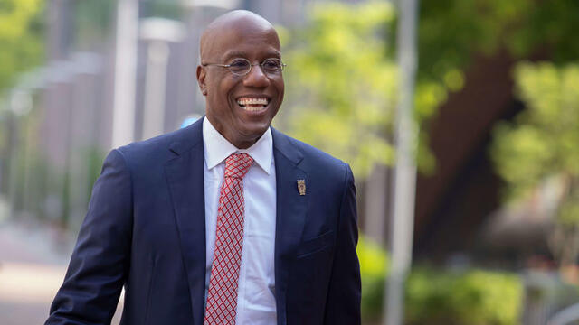 Temple President Jason Wingard in a blue suit and red tie