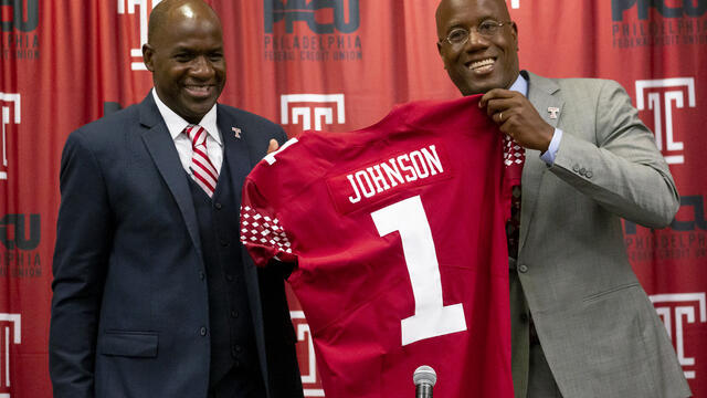 Arthur Johnson pictured with President Wingard, holding Johnson's replica Temple jersey.