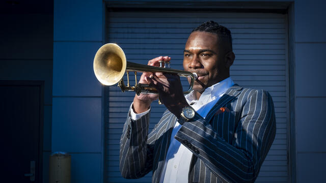 Image of Fareed Simpson-Hankins playing trumpet outside.