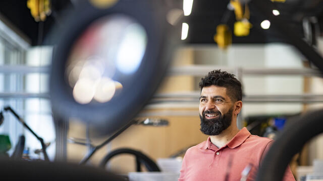 Image of Iyad Obeid sitting in an engineering lab.