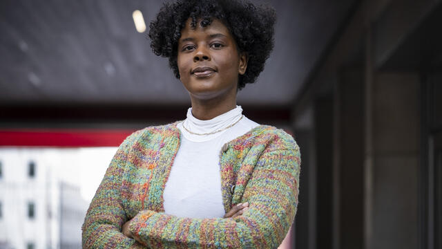 Jazmin Evans standing with her arms crossed on campus