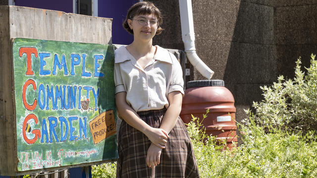 Hamilton poses near the Temple Community Garden sign