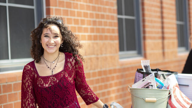 a student smiles while moving out