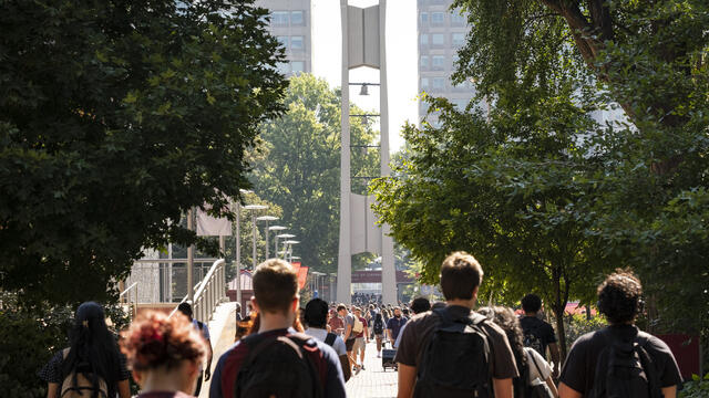 Temple students walk to class in front of the campus iconic Bell Tower.
