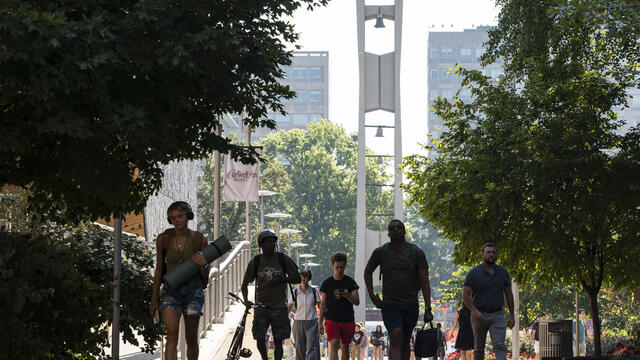 Students walking with the Bell Tower in the background