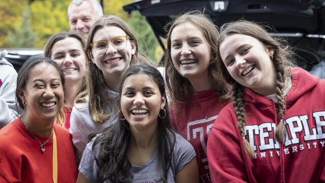 Temple students wearing Temple logo gear.