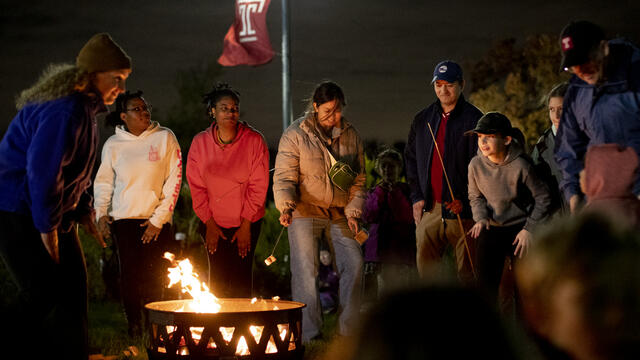 Attendees roasting marshmallows.