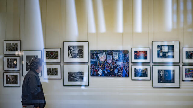 Image of a photo exhibit in a white room on the first floor of Charles Library at Temple University.