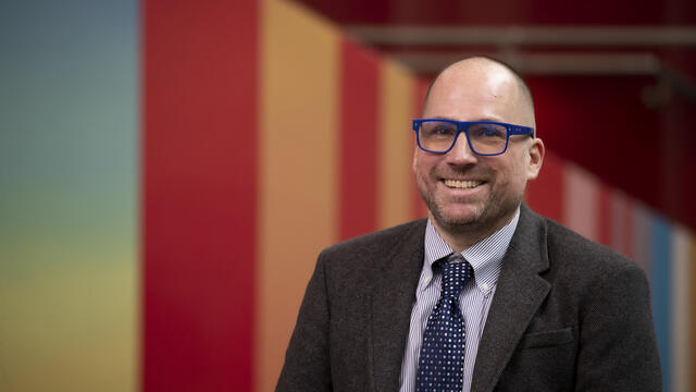 Dustin Kidd wearing blue glasses