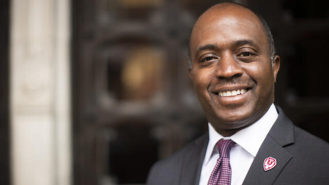 mage of Tony Thurmond in a suit and tie with an Owlmark lapel pin.