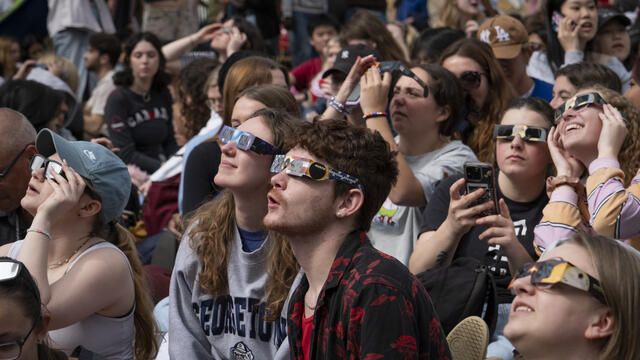 Image of students wearing eclipse glasses to view the April 8 solar eclipse.