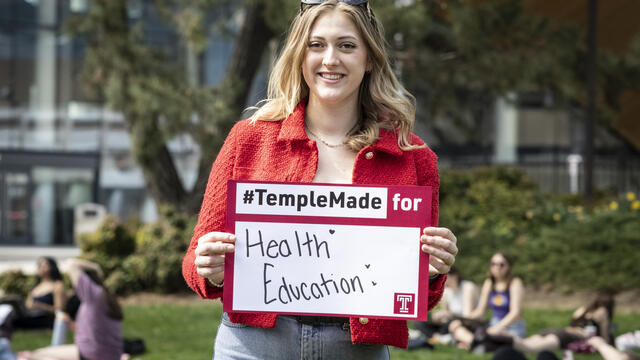 Meredith Kearney holding a Temple Made for sign