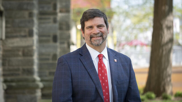 Josh Gladden standing outside on campus