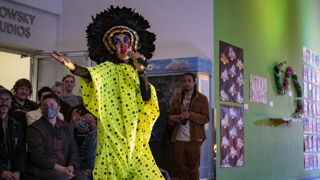 Host in an elaborate yellow and black costume