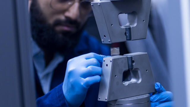 A graduate researcher working in the Electric Vehicle Safety Lab