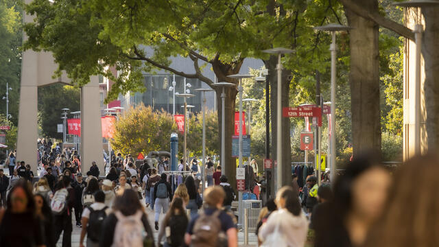 A campus scene of lots of students.