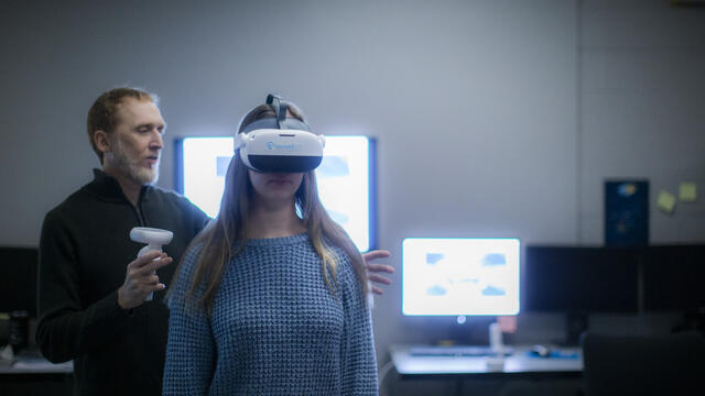 W. Geoffrey Wright with a research assistant wearing the UprightVR headset in the Motion-Action-Perception Laboratory