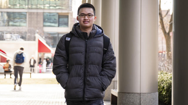 Edmond Tsan walks through campus