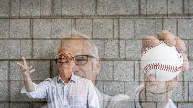 Image of a college professor tossing an MLB baseball.