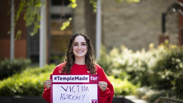 Ray Epstein holding a Temple Made for sign outside of Main Campus