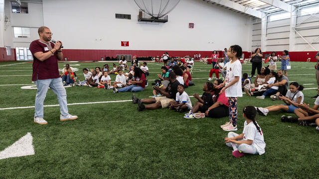 Image of Timothy Welbeck addressing the crowd at the Family Field Day event.