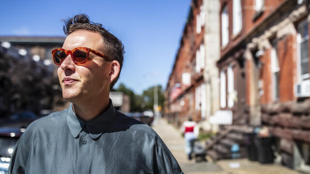 Bench Ansfield standing outside a neighborhood near Main Campus