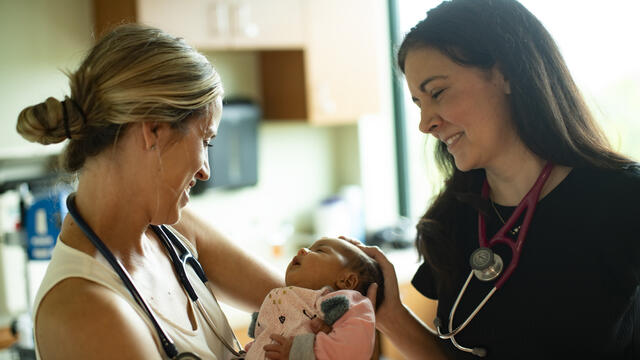 Female physicians with a baby