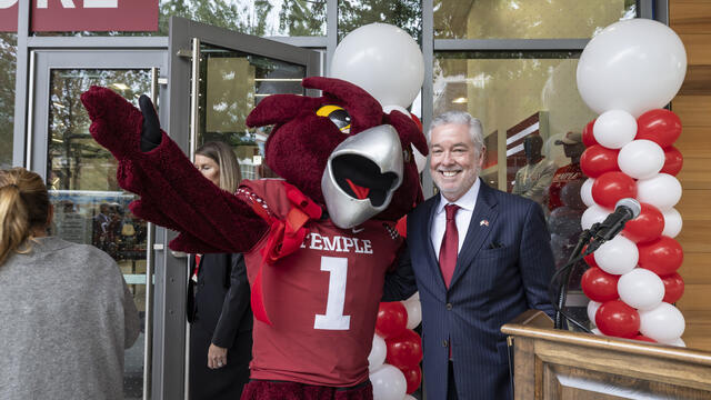 President Fry poses with Hooter the Owl mascot at bookstore grand opening