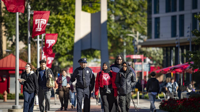 Image of three former Carver High School students with a Temple police officer.