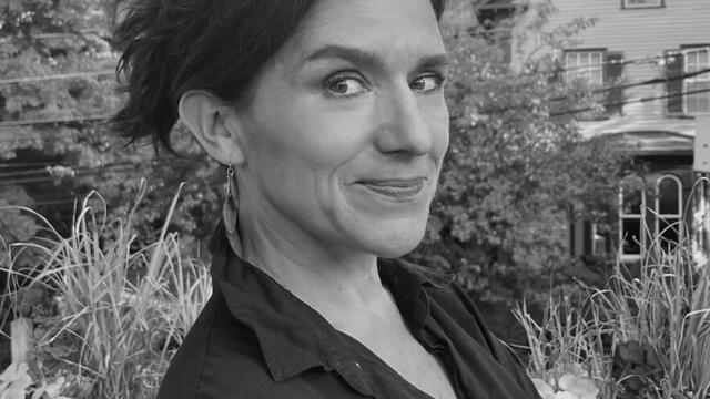 Gretchen Heefner starring at the camera with crossed amrs