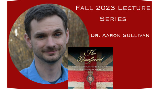 Dr. Aaron Sullivan standing in the woods wearing a blue button down shirt