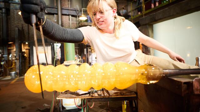 Image of Gemma Hollister creating a glass hamster tube on the set of Blown Away.
