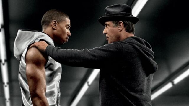 A poster promoting the film Creed with stars posing in a boxing ring.