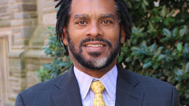 Image of Donald P. Harris standing in front of a tree.