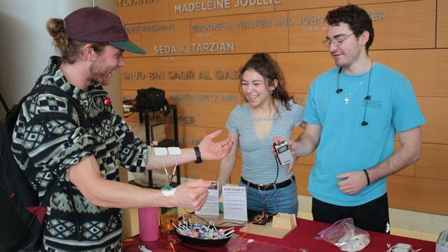 students with biomechanical arm
