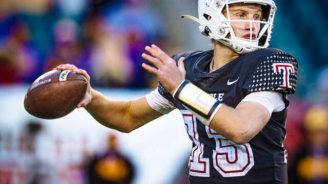 Image of a college athlete wearing a white helmet with a Temple logo and a black, cherry and white jersey, throwing a football.