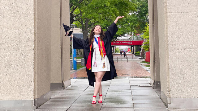 Roth poses in cap and gown at the Bell Tower
